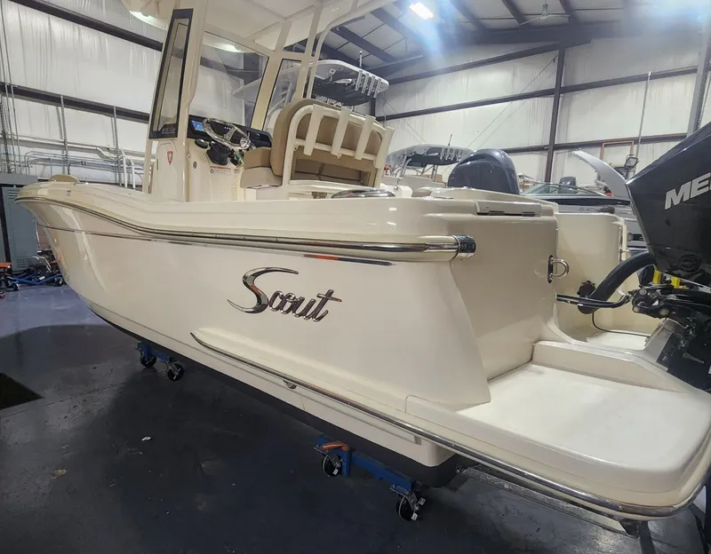 Slide: The Image of 2023 Scout 215 XSF boat in a warehouse. - 2