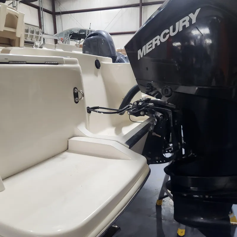 Slide: The Image of Scout 215 XSF 2023 with Mercury outboard motor in warehouse. - 3