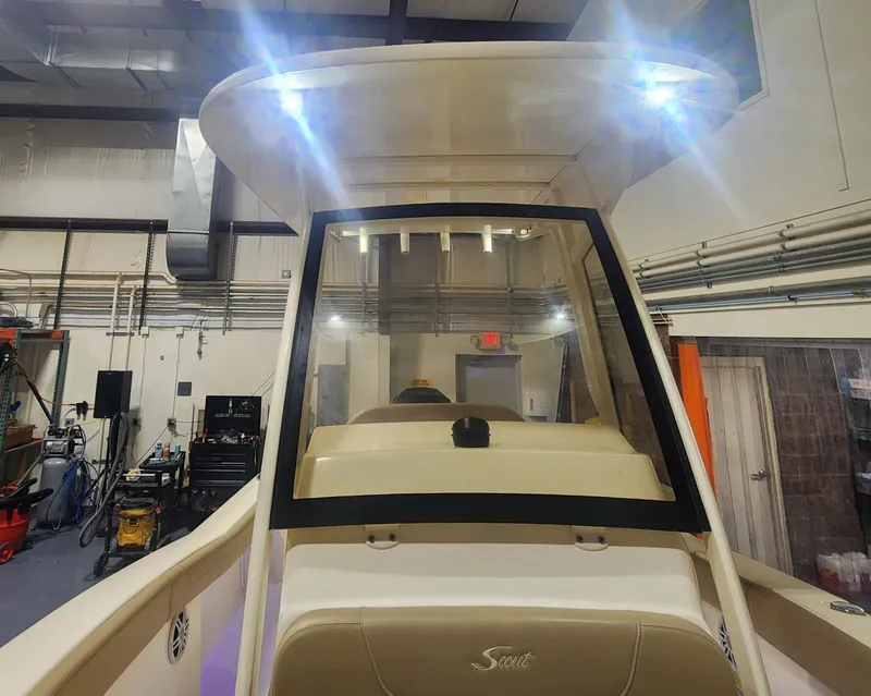Slide: The Image of 2023 Scout 215 XSF boat in a workshop with lighting. - 32
