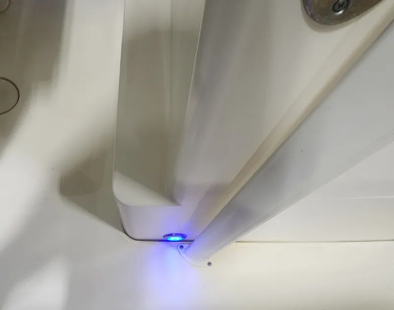 Slide: The Image of Interior view of 2023 Scout 215 XSF with blue LED lighting. - 36