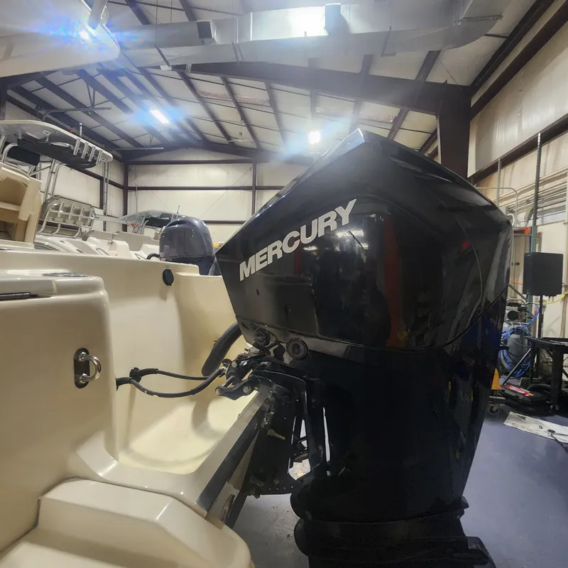 Slide: The Image of 2023 Scout 215 XSF with Mercury outboard motor in warehouse. - 4