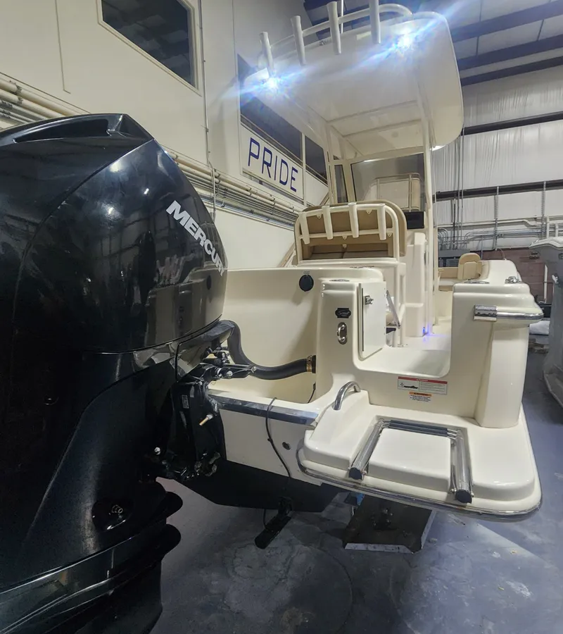 Slide: The Image of 2023 Scout 215 XSF boat with Mercury engine in a warehouse. - 6