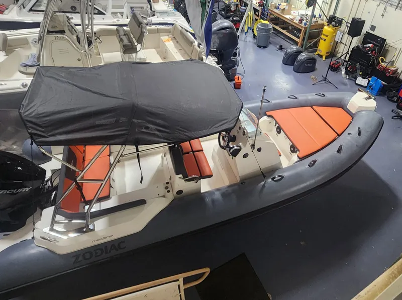 Slide: The Image of 2024 Zodiac Medline 6.8 inflatable boat with canopy and orange seating. - 2