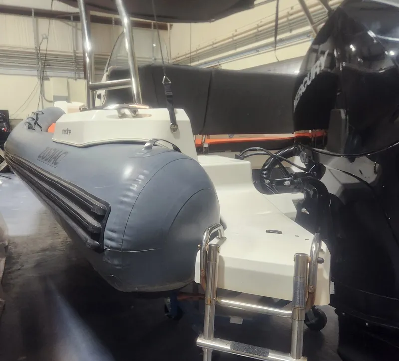 Slide: The Image of 2024 Zodiac Medline 6.8 boat with outboard motor in a workshop. - 7
