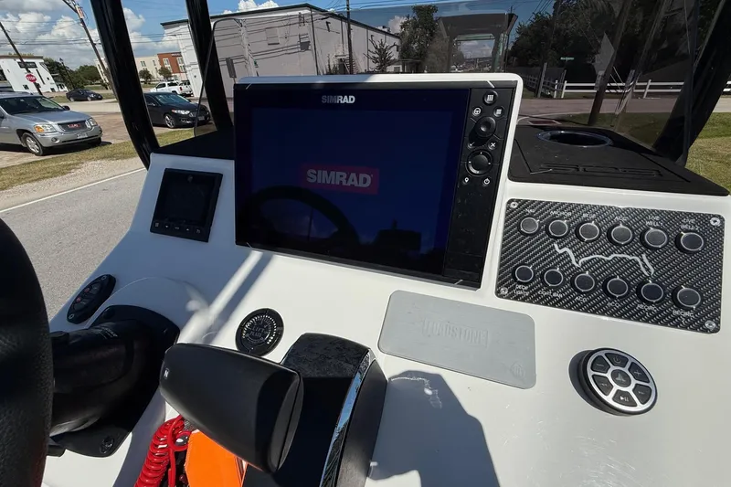 Slide: The Image of 2024 SCB S22 boat dashboard with Simrad display and control panel. - 16