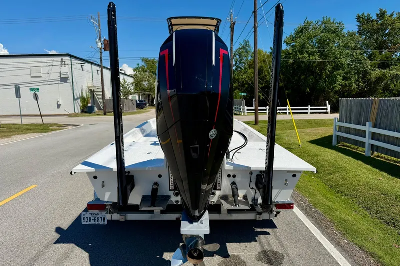 Slide: The Image of 2024 SCB S22 boat on trailer, rear view, parked on a sunny street. - 3