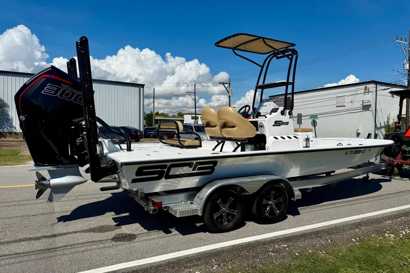 Slide: The Image of 2024 SCB S22 boat with powerful engine on trailer, parked outdoors under blue sky. - 4
