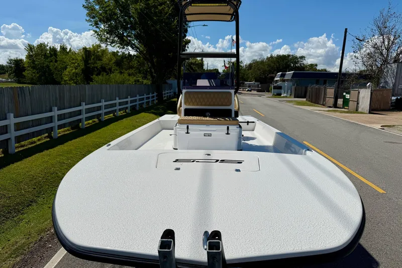 Slide: The Image of 2024 SCB S22 boat on a road, showcasing sleek design and spacious deck. - 6