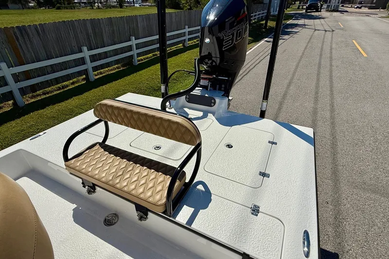 Slide: The Image of 2024 SCB S22 boat with tan seating and powerful outboard motor on a sunny day. - 7