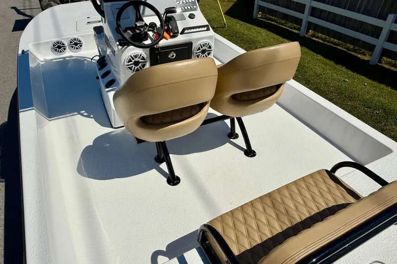 Slide: The Image of 2024 SCB S22 boat interior with tan seats and steering console. - 8