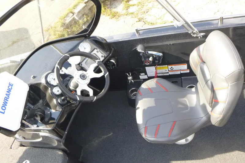 Slide: The Image of 2023 Nitro ZV19 Sport Pro boat cockpit with steering wheel and Lowrance equipment. - 12