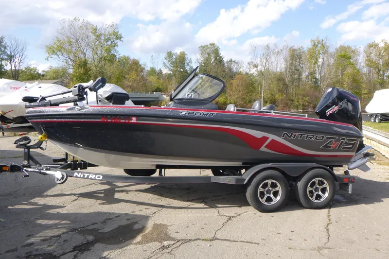 Slide: The Image of 2023 Nitro ZV19 Sport Pro boat on trailer, parked outdoors. - 2