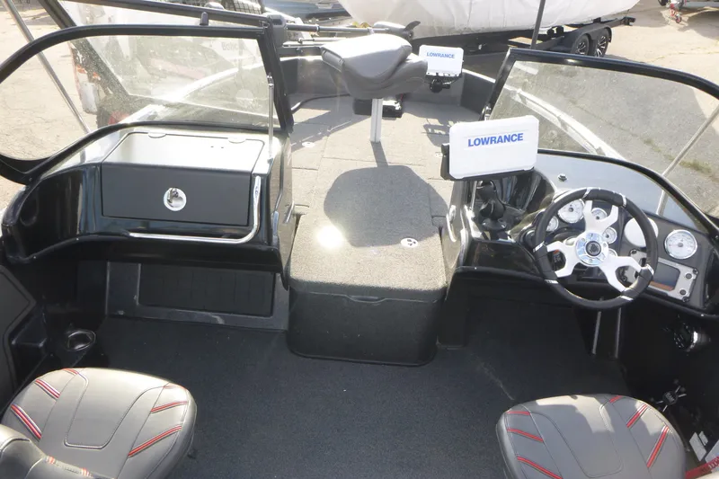 Slide: The Image of 2023 Nitro ZV19 Sport Pro boat interior with steering wheel and Lowrance electronics. - 6