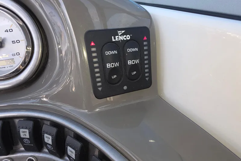 Slide: The Image of Control panel of 2013 Rinker 276 Captiva Bowrider with Lenco trim tab switches. - 15