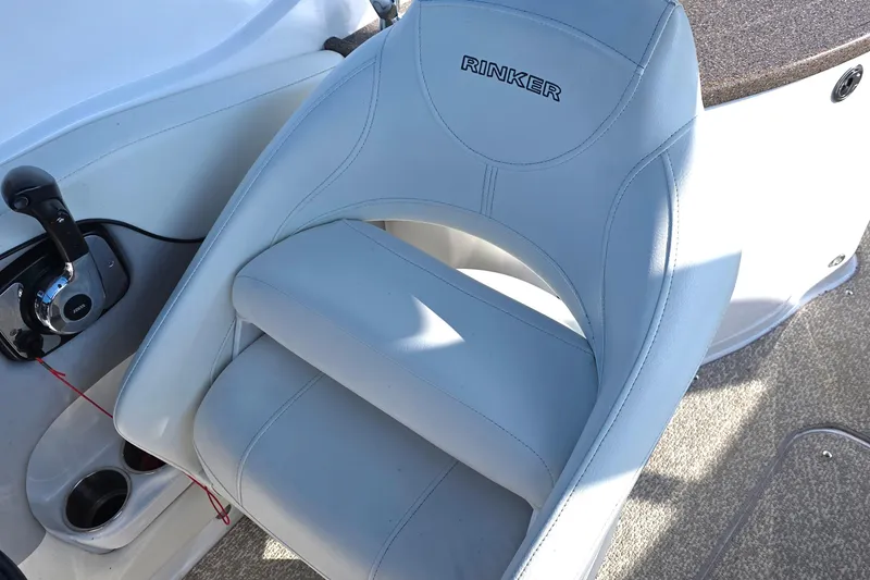 Slide: The Image of 2013 Rinker 276 Captiva Bowrider cockpit with white leather seat and control panel. - 26