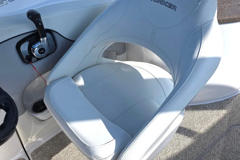 Slide: The Image of 2013 Rinker 276 Captiva Bowrider cockpit with white seat and control lever. - 27