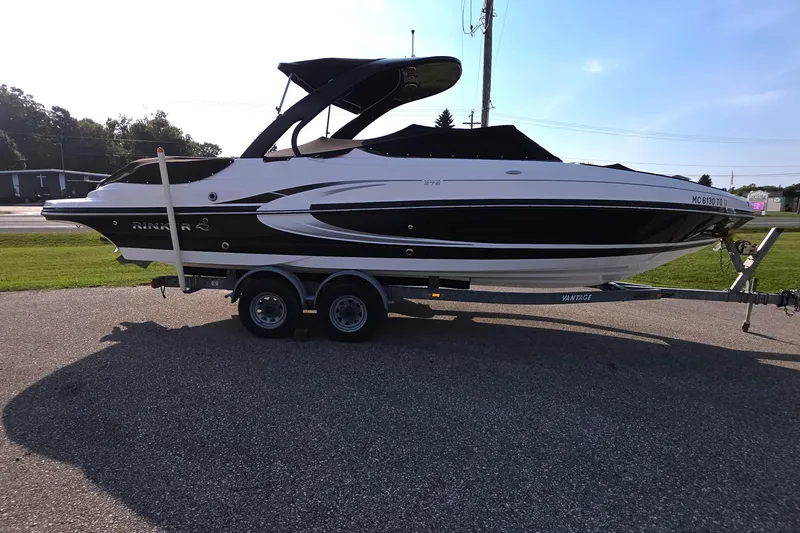 Slide: The Image of 2013 Rinker 276 Captiva Bowrider on trailer, parked outdoors, side view. - 3