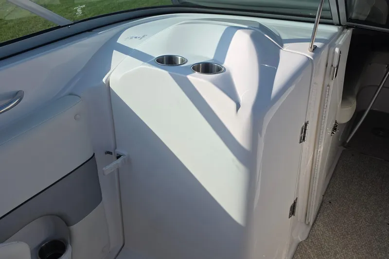 Slide: The Image of 2013 Rinker 276 Captiva Bowrider interior with cup holders and storage compartment. - 30