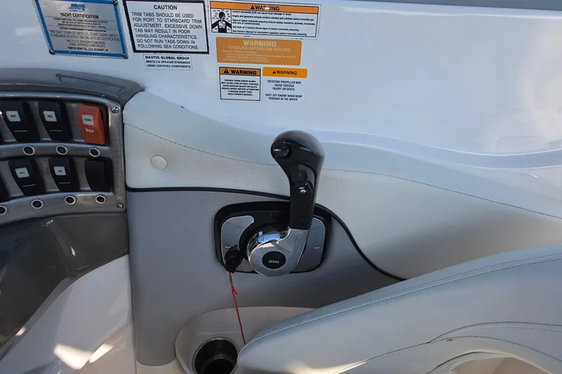 Slide: The Image of Control panel of a 2013 Rinker 276 Captiva Bowrider boat with warning labels. - 31