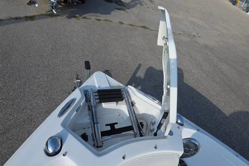 Slide: The Image of 2013 Rinker 276 Captiva Bowrider with open storage compartment on deck. - 35