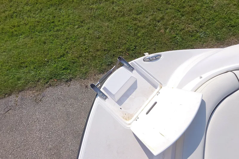 Slide: The Image of 2013 Rinker 276 Captiva Bowrider bow with ladder and grassy background. - 36