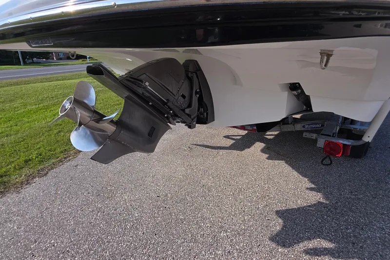 Slide: The Image of 2013 Rinker 276 Captiva Bowrider boat propeller and stern on a trailer. - 42