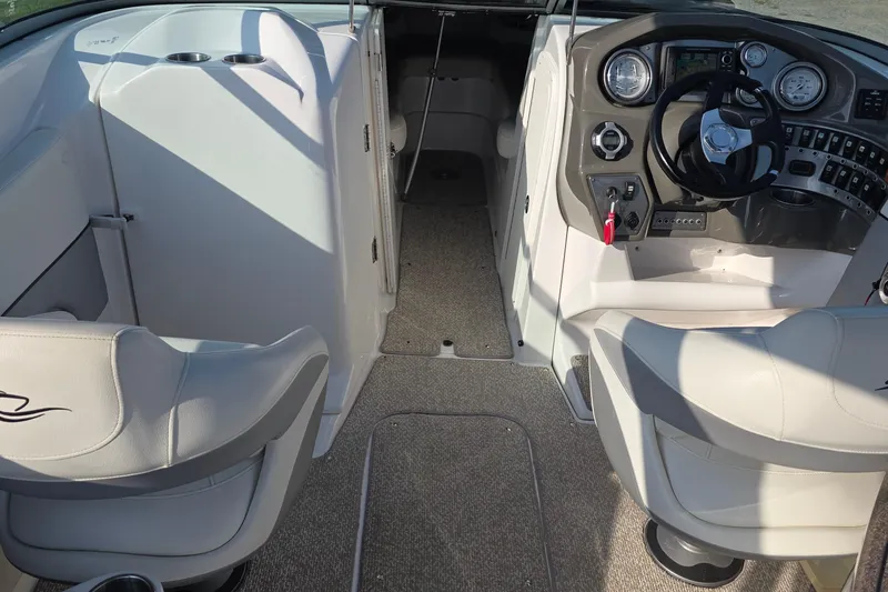 Slide: The Image of 2013 Rinker 276 Captiva Bowrider interior with steering wheel and seating. - 6