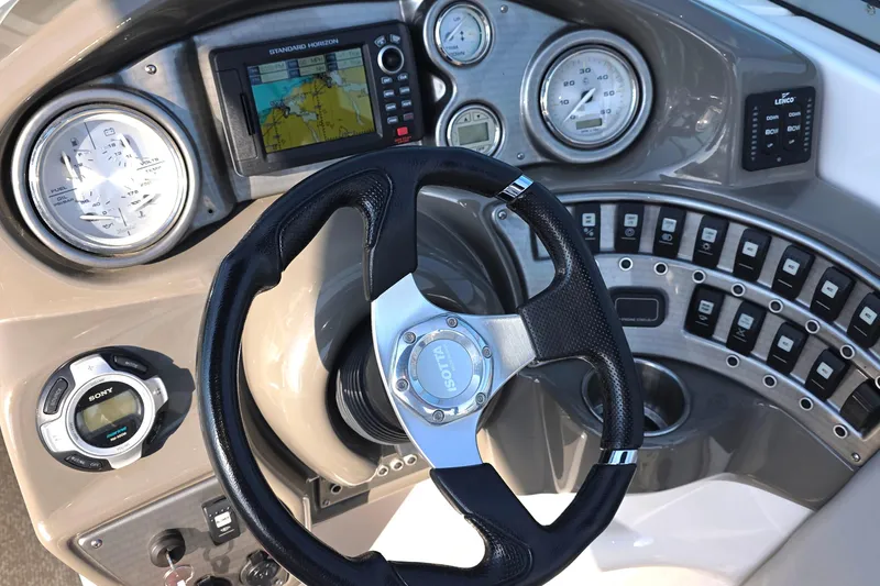 Slide: The Image of Dashboard of 2013 Rinker 276 Captiva Bowrider with steering wheel and navigation controls. - 9
