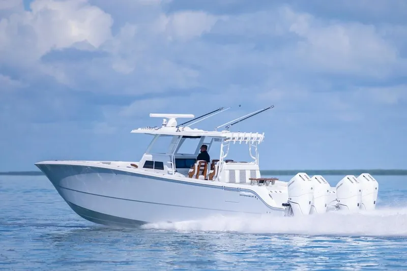 Slide: The Image of 2026 Invincible 46 Catamaran cruising on calm waters under a cloudy sky. - 11