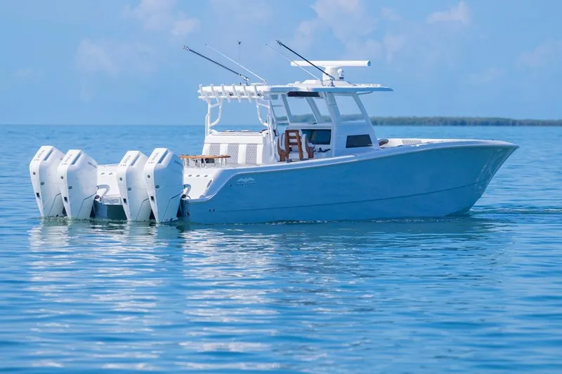 Slide: The Image of 2026 Invincible 46 Catamaran on calm blue water, featuring four powerful outboard engines. - 2