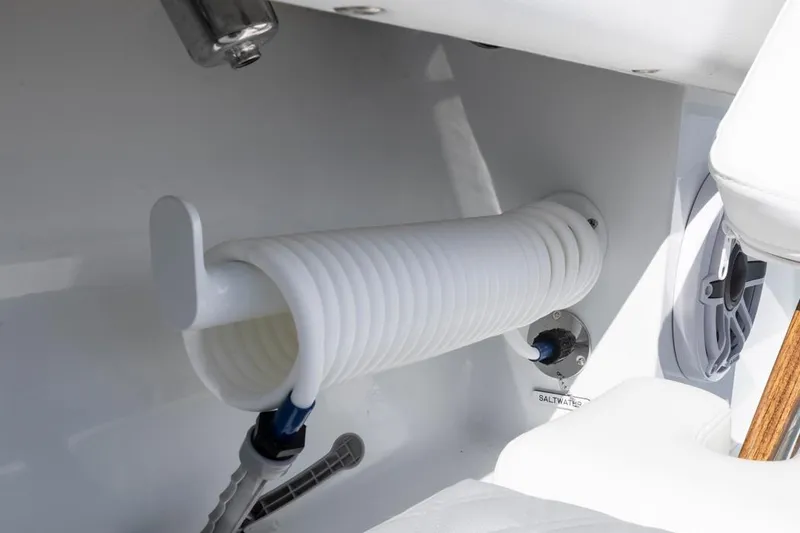 Slide: The Image of White coiled hose in Invincible 46 Catamaran, 2026 model, with saltwater connection. - 26