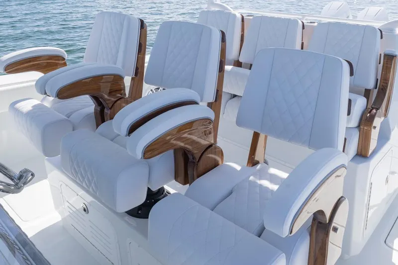 Slide: The Image of Luxurious seating on 2026 Invincible 46 Catamaran, featuring elegant white upholstery and wooden accents. - 37