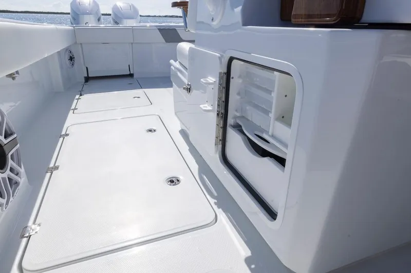 Slide: The Image of 2026 Invincible 46 Catamaran deck with storage compartments and sleek design. - 52