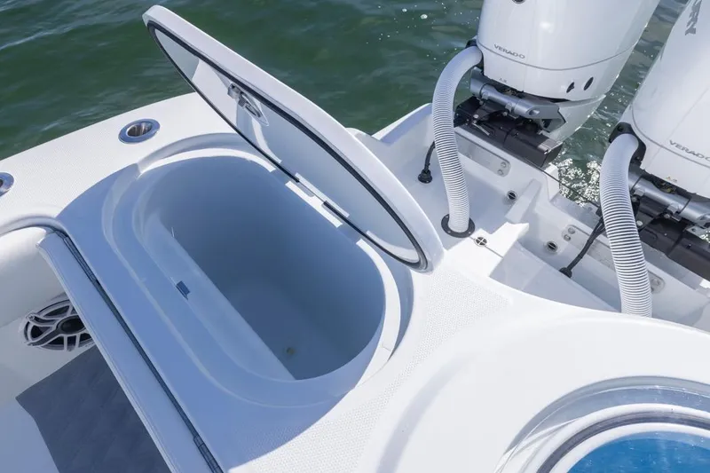 Slide: The Image of Open storage compartment on 2026 Invincible 46 Catamaran with dual outboard engines. - 63