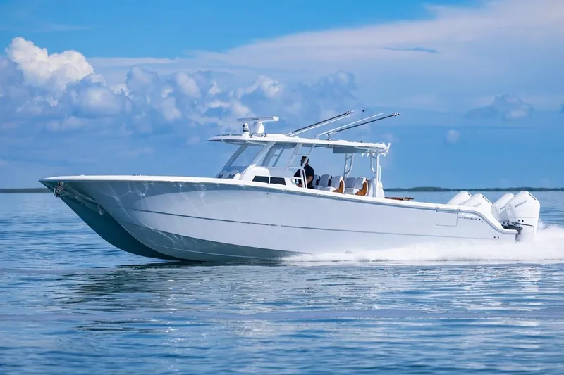 Slide: The Image of 2026 Invincible 46 Catamaran cruising on calm ocean waters under a clear blue sky. - 8