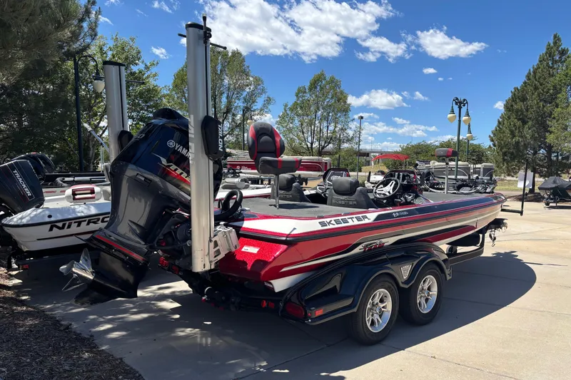 Slide: The Image of 2017 Skeeter FX21 boat with Yamaha engine on a trailer, parked outdoors. - 6