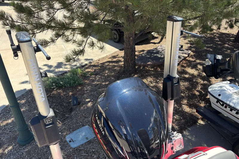 Slide: The Image of 2017 Skeeter FX21 boat with Minn Kota trolling motors in a wooded area. - 7