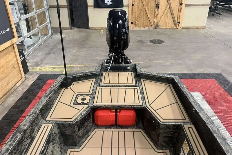 Slide: The Image of 2026 Tracker Grizzly 1650 T Prairie Wings Edition boat interior with motor and storage compartments. - 5