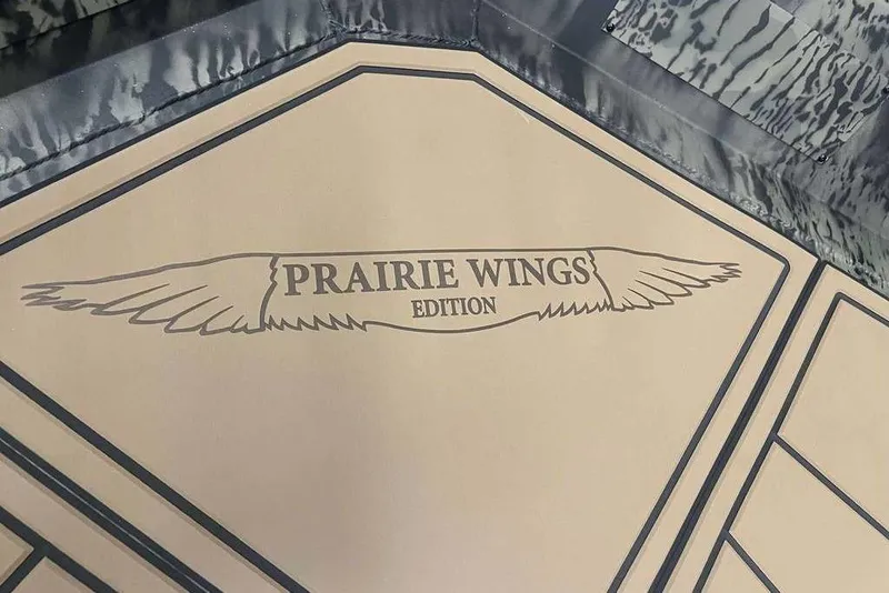 Slide: The Image of 2026 Tracker Grizzly 1650 T Prairie Wings Edition logo with wing design. - 6