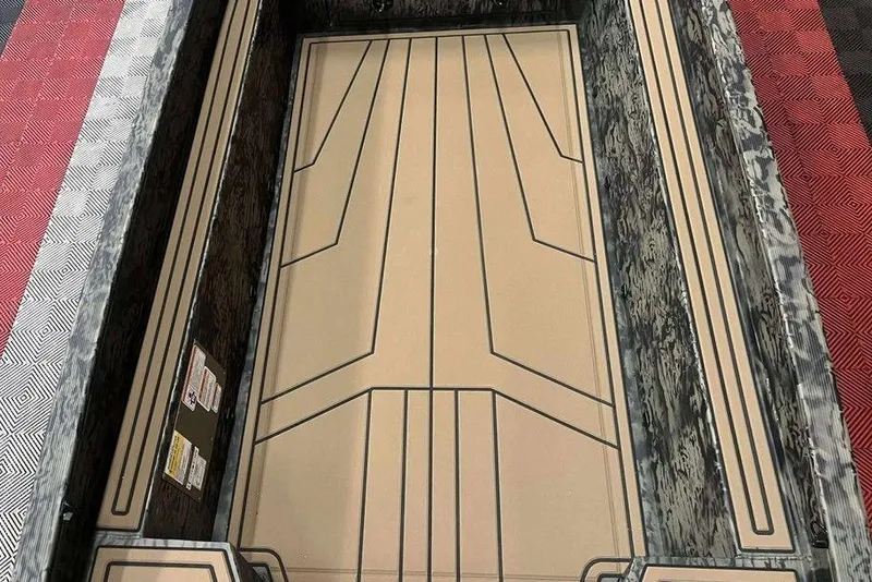 Slide: The Image of Interior view of 2026 Tracker Grizzly 1650 T Prairie Wings Edition boat, featuring a sleek, patterned floor design. - 7