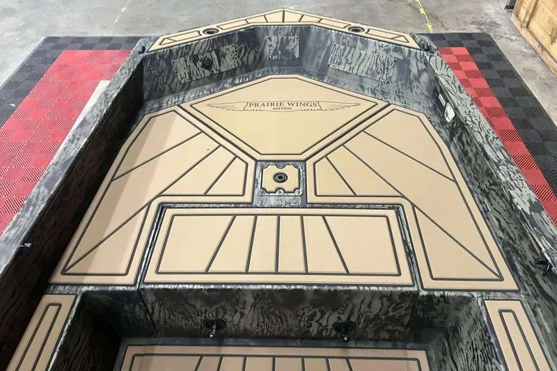 Slide: The Image of 2026 Tracker Grizzly 1650 T Prairie Wings Edition boat interior with custom flooring design. - 8