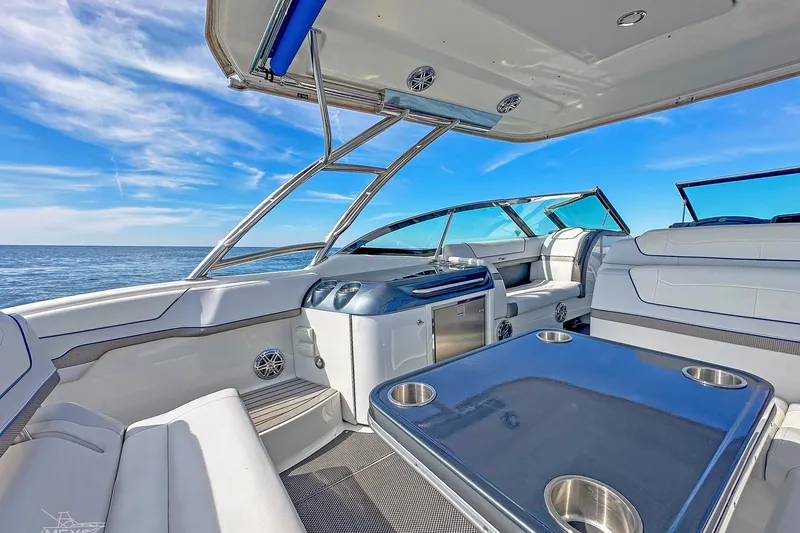 Slide: The Image of 2018 Formula 350 FX Crossover Bowrider interior with ocean view, featuring luxurious seating and table. - 18
