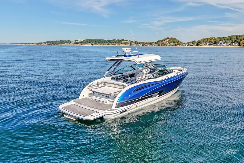 Slide: The Image of 2018 Formula 350 FX Crossover Bowrider on serene blue water, coastal background. - 2
