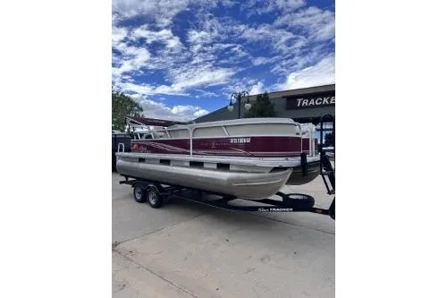 Slide: The Image of 2013 Sun Tracker Party Barge 22 DLX pontoon boat on trailer under blue sky. - 3