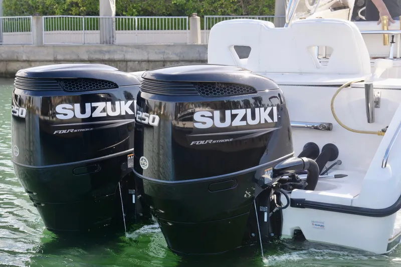 Slide: The Image of Twin Suzuki 250 outboard engines on a 1999 Pursuit 2870 Walkaround boat. - 23