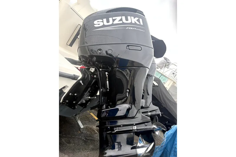 Slide: The Image of Suzuki outboard motor on a 1999 Pursuit 2870 Walkaround boat, showcasing powerful performance. - 25