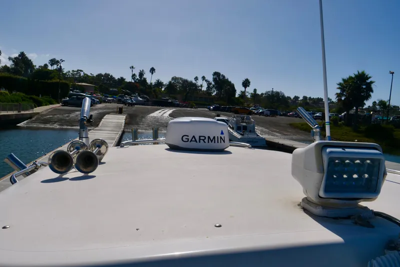 Slide: The Image of 1999 Pursuit 2870 Walkaround boat with Garmin equipment at a dock. - 4