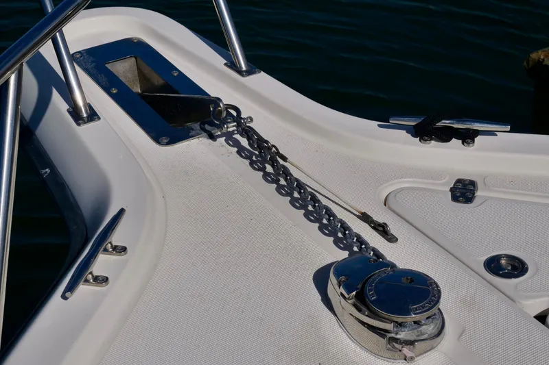 Slide: The Image of 1999 Pursuit 2870 Walkaround boat deck with anchor chain and winch. - 8