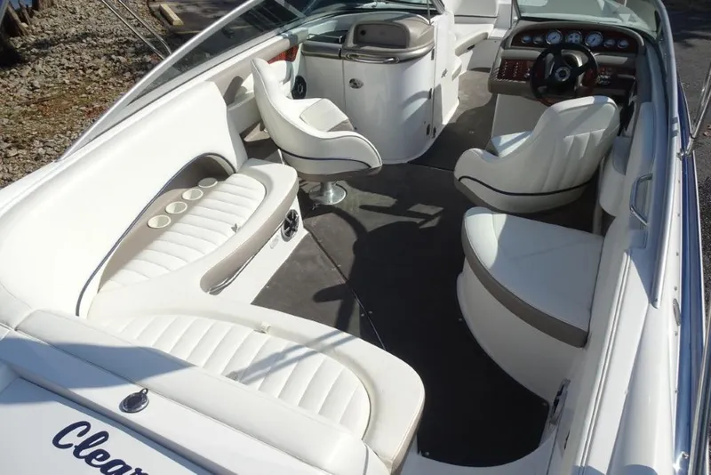 Slide: The Image of 2003 Cobalt 24SD boat interior with white seating and modern dashboard. - 10