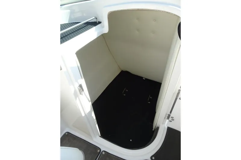 Slide: The Image of 2003 Cobalt 24SD boat interior storage compartment, white and black design. - 16